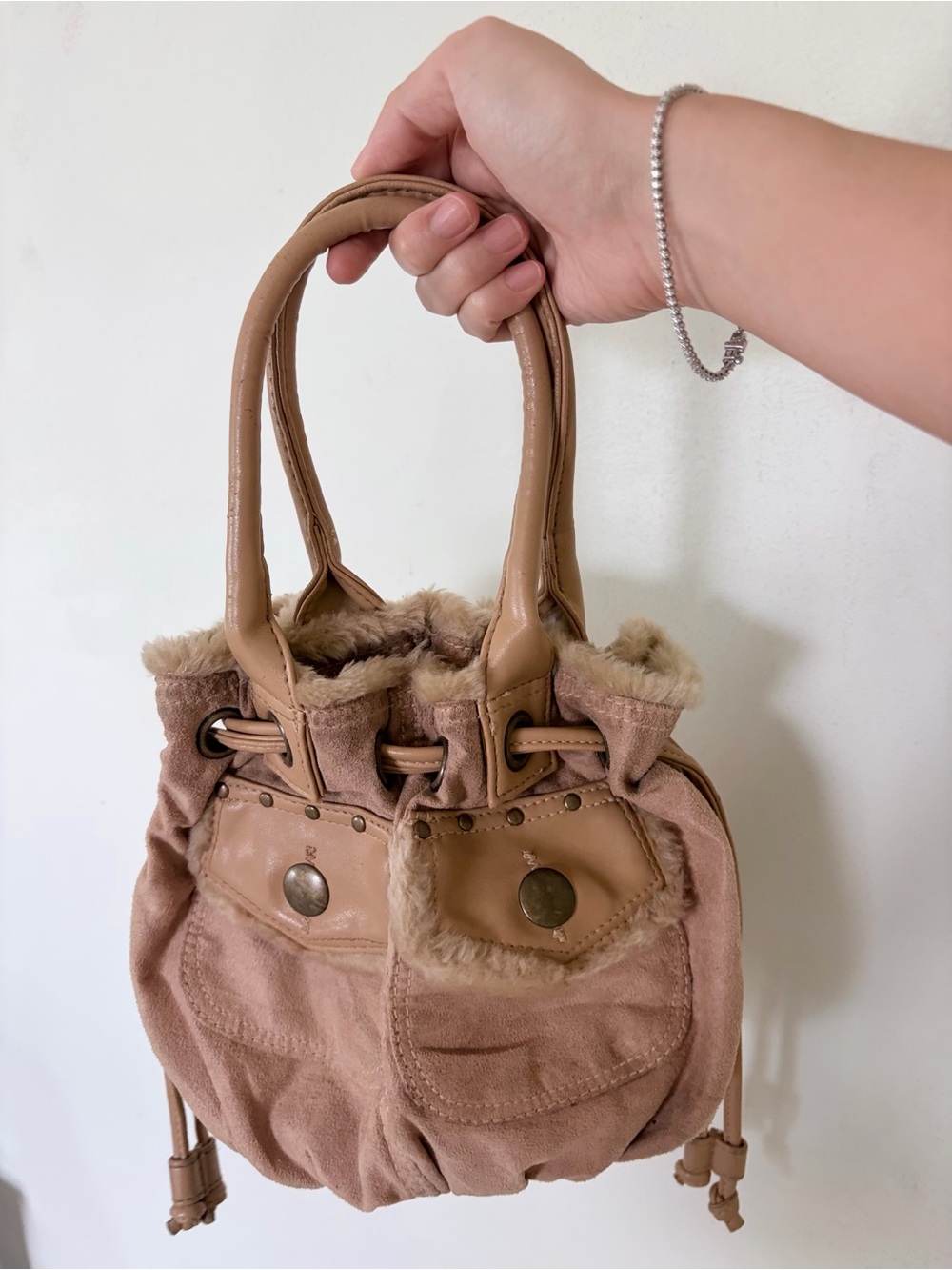 Y2K tan/beige suede and leather drawstring bucket-style handbag featuring dual t